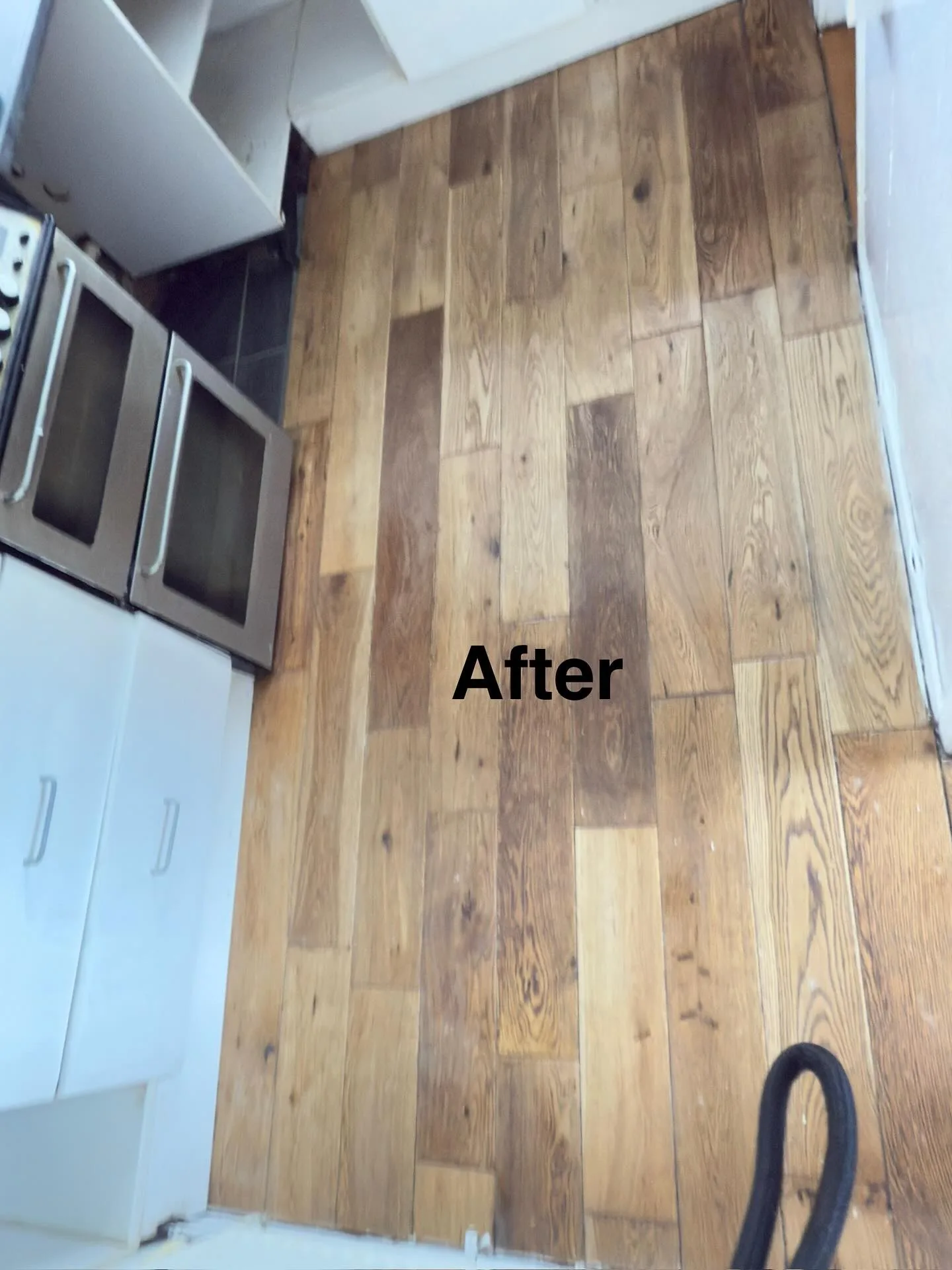 Freshly cleaned and restored hardwood floor with a rich, glossy finish