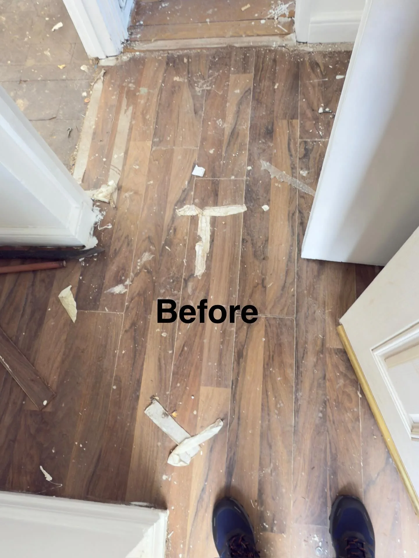Bare hardwood floor covered in dust and offcuts before a deep clean