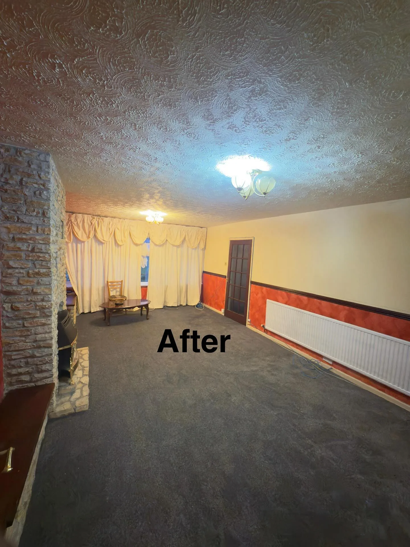 Same living room clean and clear with stone fireplace on show