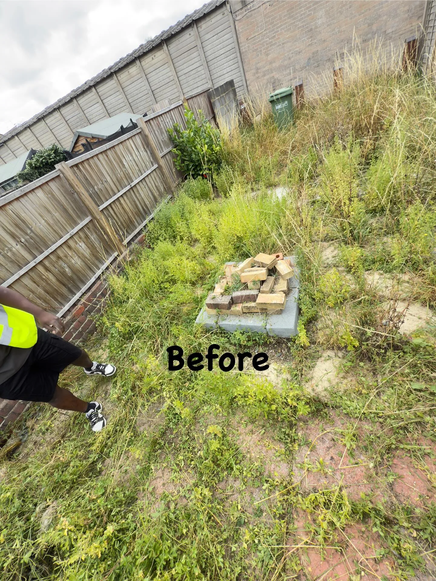 Garden side passage cluttered before clearance, with our team on site